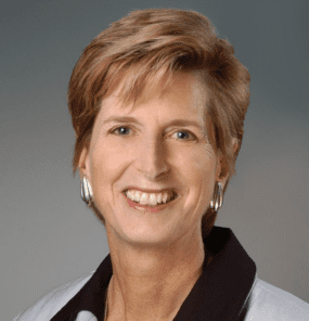 Christine Todd Whitman, short blonde hair with a black and gray shirt