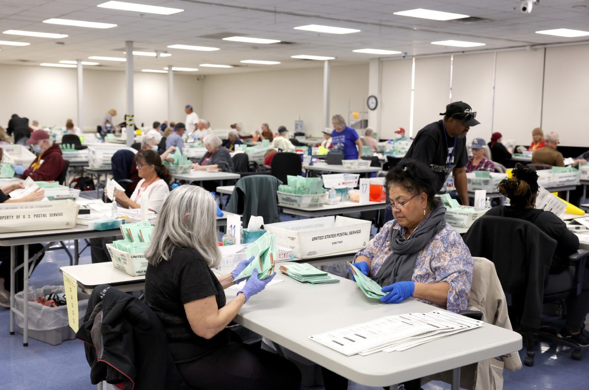 Election workers open mail in ballots at the Maricopa County Tabulation and Election Center on November 11, 2022 in Phoenix, Arizona. Ballots continue to be counted in Maricopa County three days after voters went to the polls for the midterm election in Arizona. (Photo by Justin Sullivan/Getty Images)